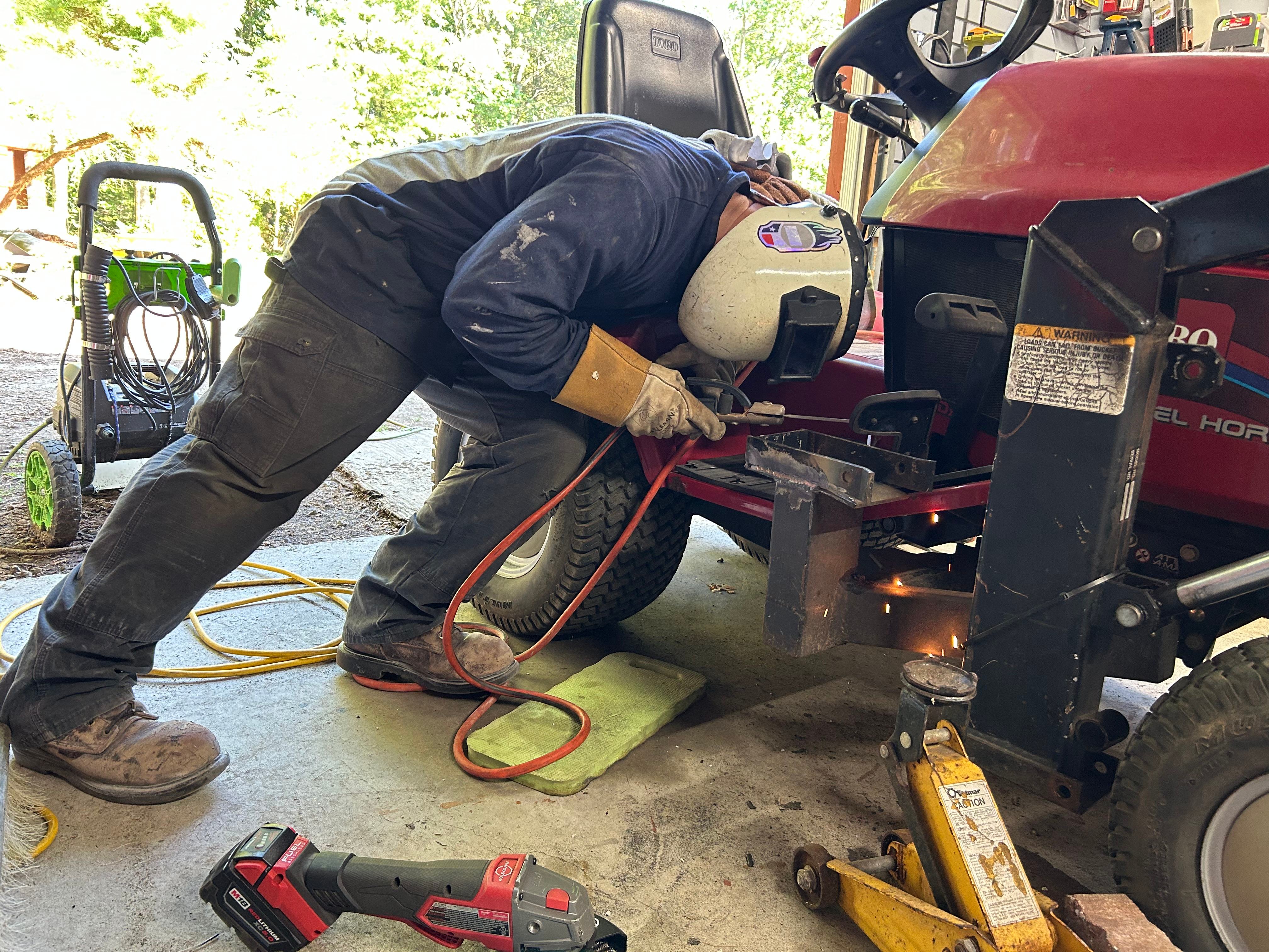 Mobile welding repair being completed on outdoor equipment
