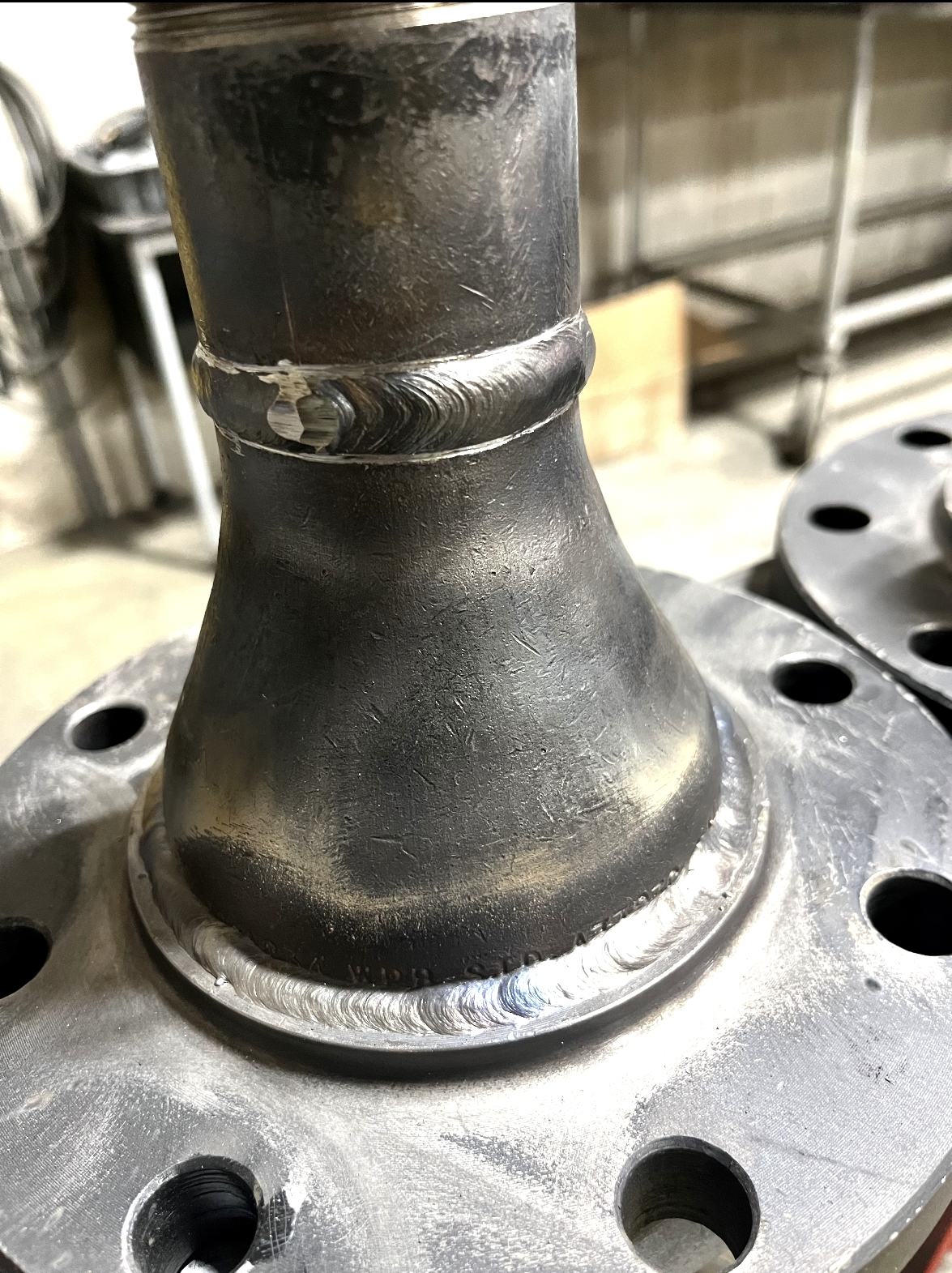 Finished welded steel fitting and flange