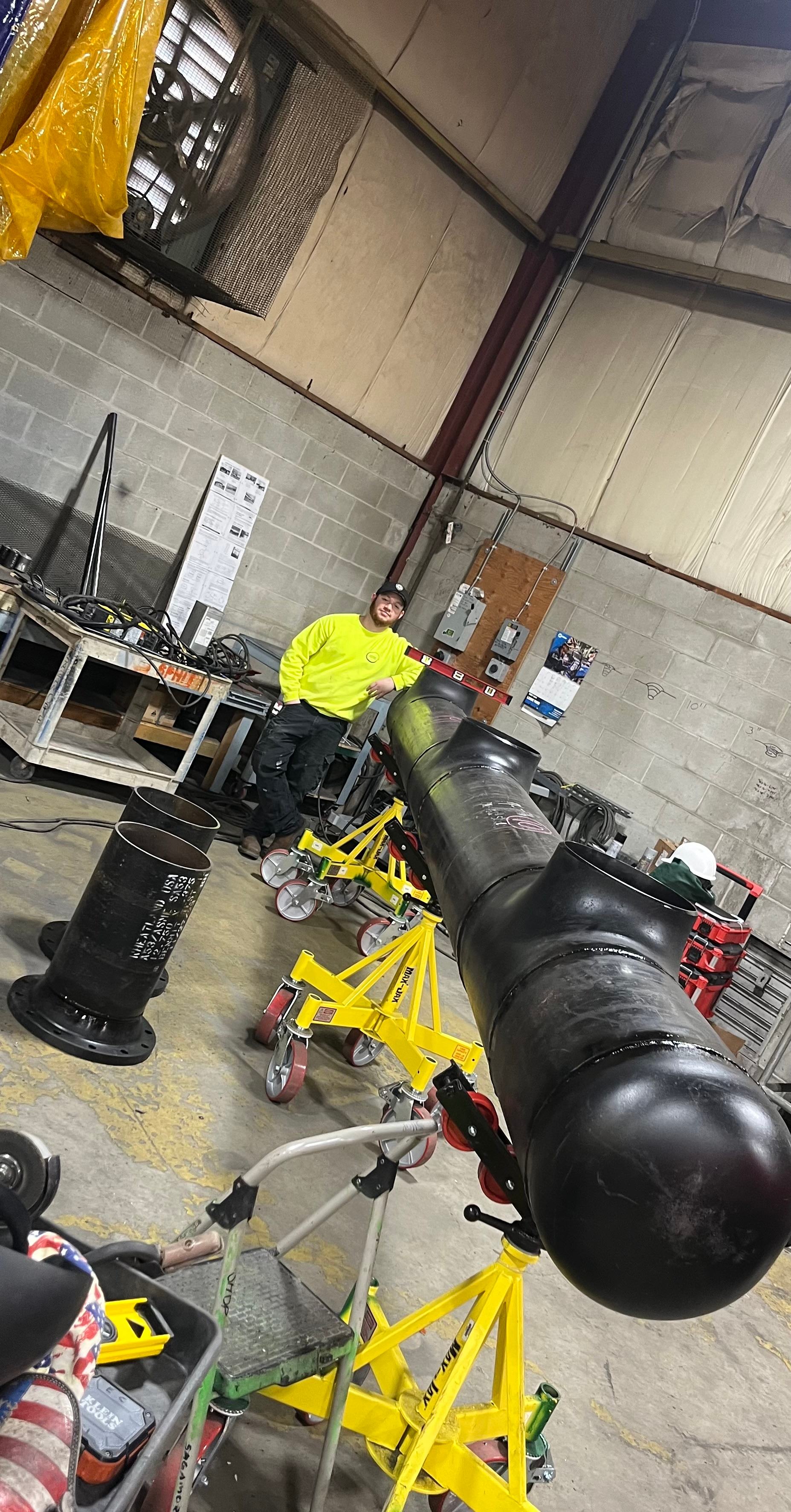 Large fabricated steel pipe assembly in a workshop